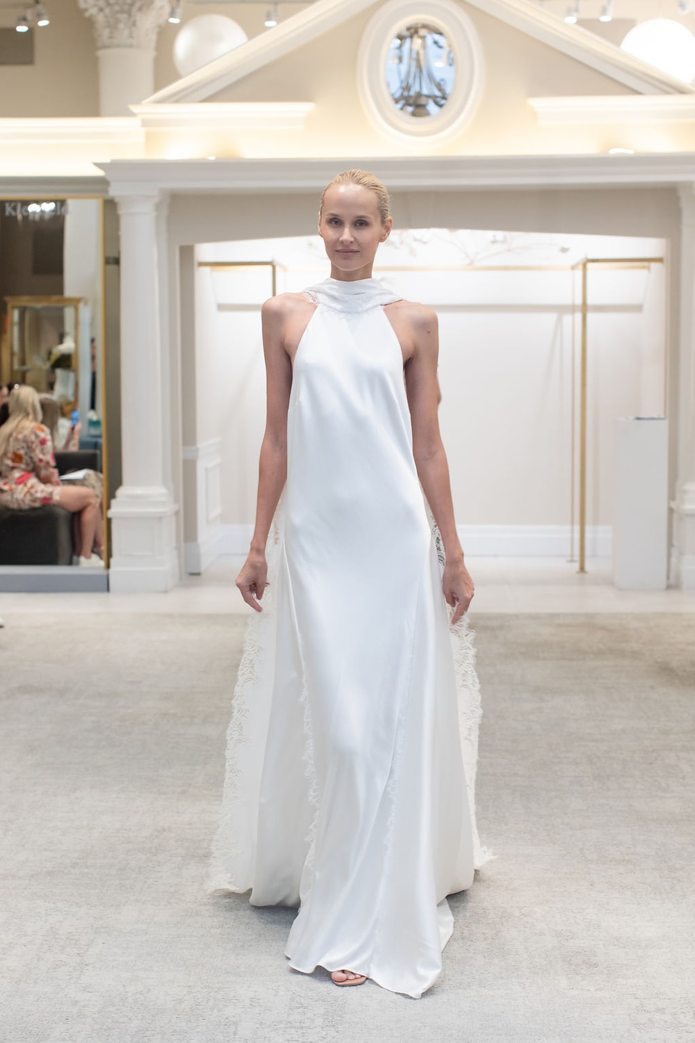 Chic and Sexy High Neck Sheath Wedding Dress with Dramatic Open Back by Martina Liana for Kleinfeld — image 1 of 3