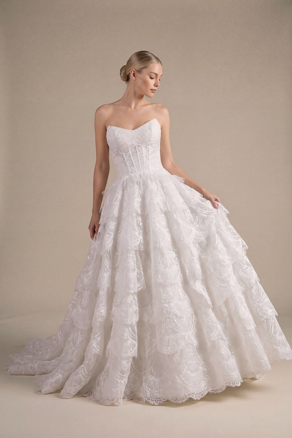 Modern Ball Gown with Beading Details and Ruffled Skirt by Kleinfeld By Viola Chan — image 1 of 3