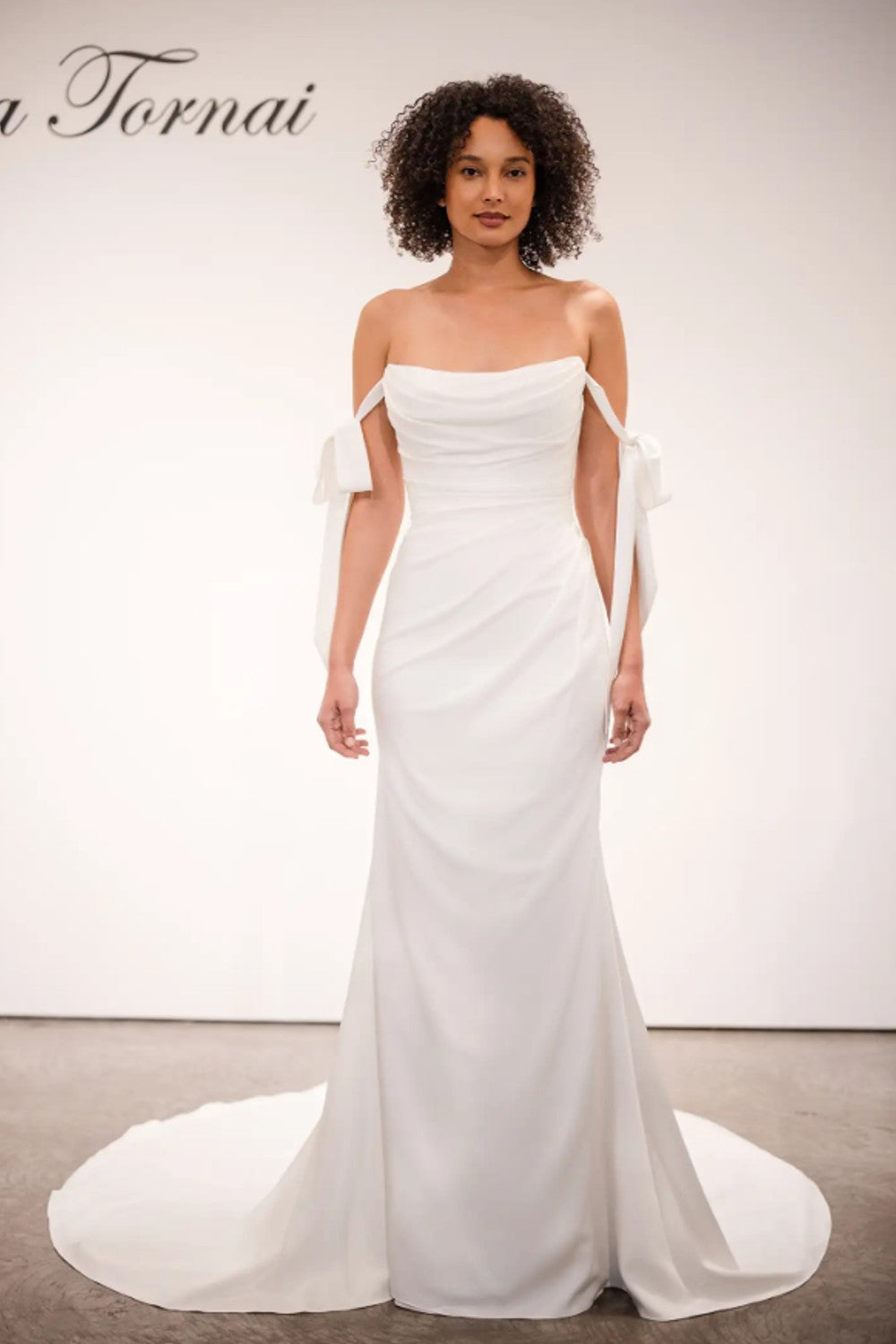 Plus-Size Minimalist Sheath Wedding Dress With Off-The-Shoulder Bows by Love by Pnina Tornai — image 1 of 2