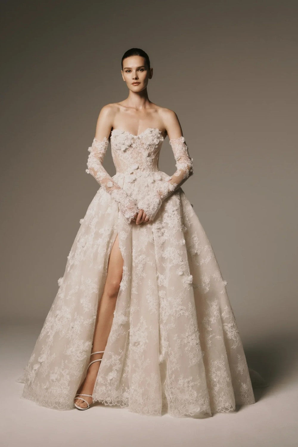 Dramatic And Romantic Lace Ball Gown With Detachable Sleeves by Nicole + Felicia For Kleinfeld — image 1 of 3