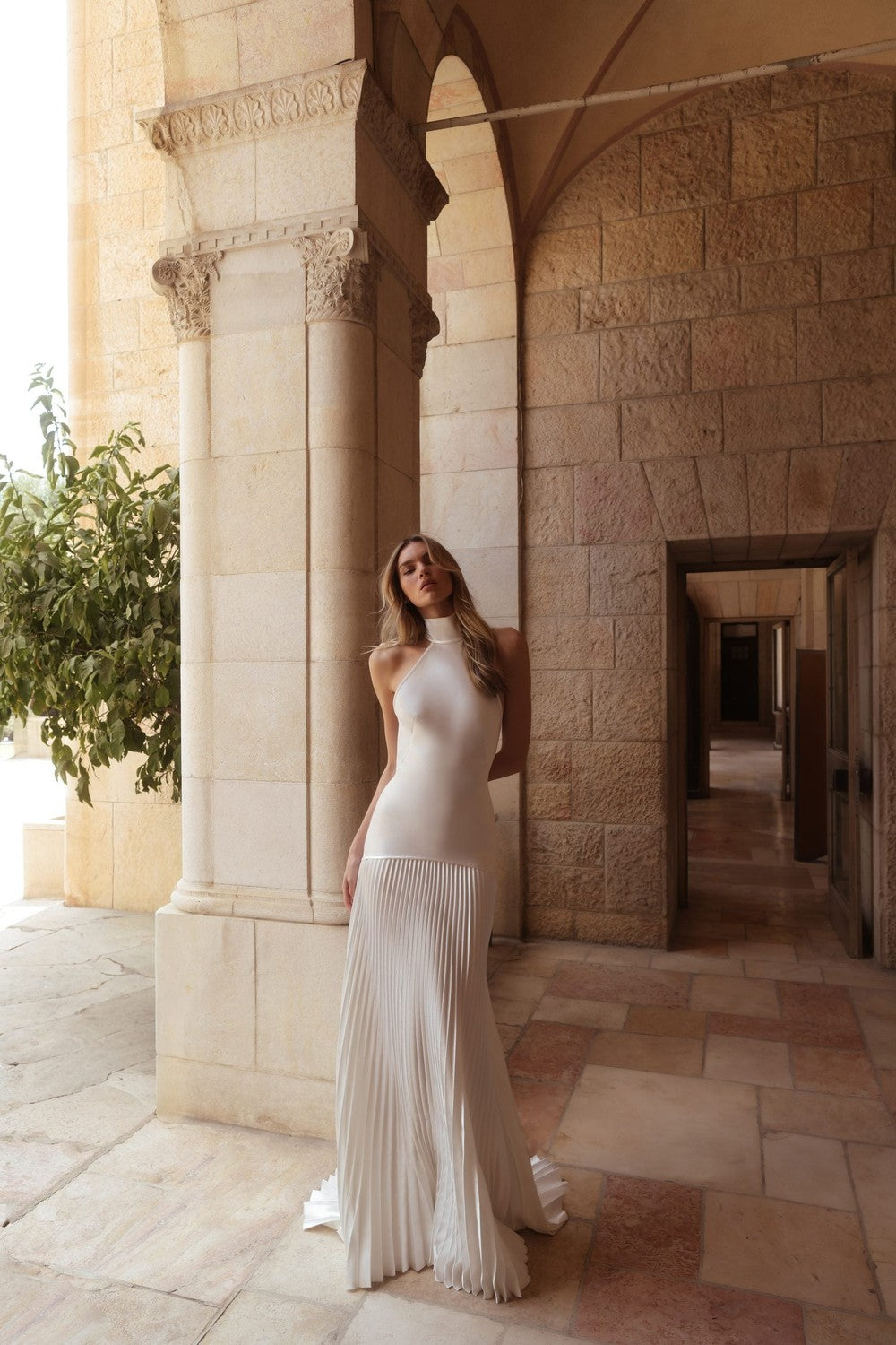 Simple Halter-Neck Drop-Waist A-Line Wedding Dress With Accordion Skirt by Pnina Tornai — image 1 of 2