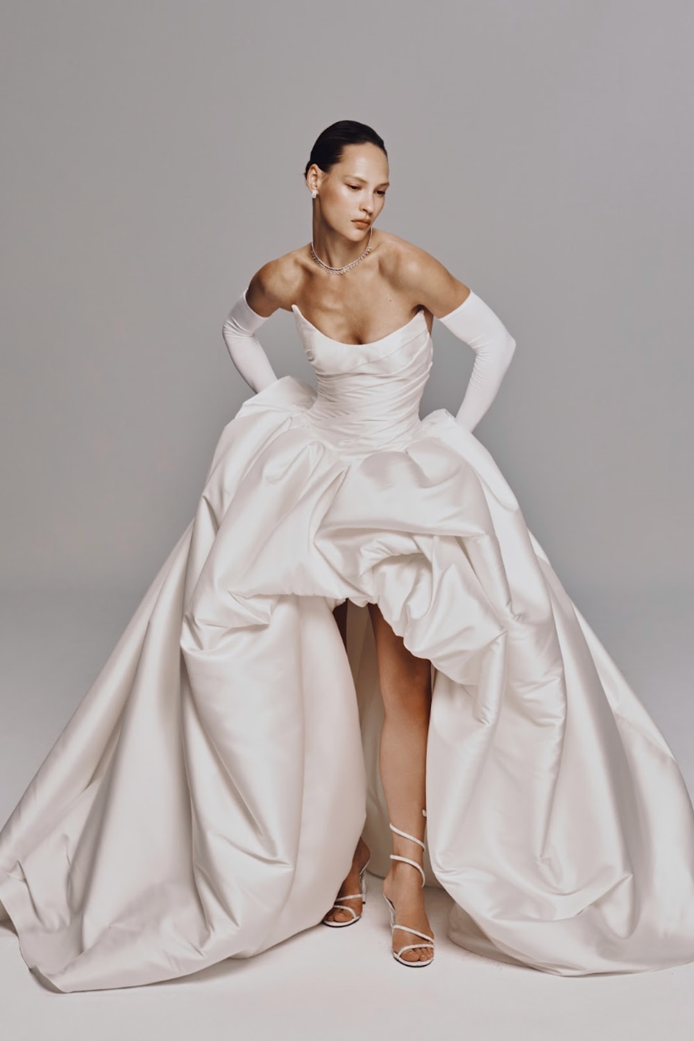 Modern and Sculptural High-Low Ball Gown by Nicole + Felicia For Kleinfeld — image 1 of 4