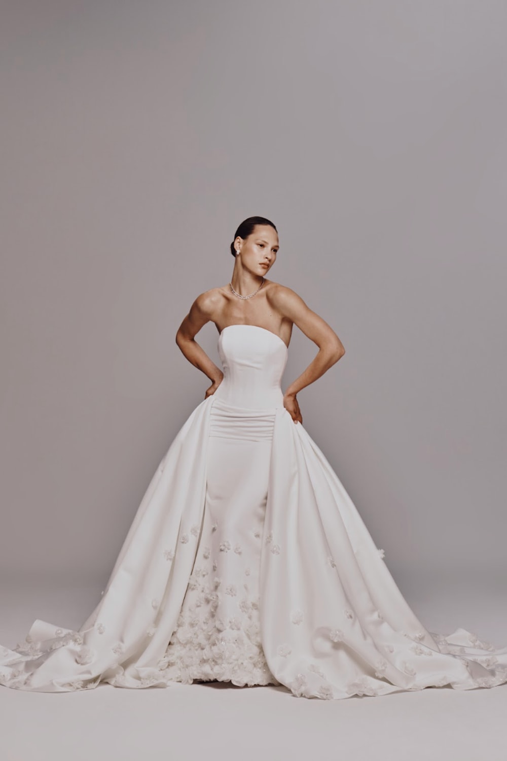 Strapless Fit-And-Flare Wedding Dress with Flower Embellishments and Detachable Train by Nicole + Felicia For Kleinfeld — image 2 of 4