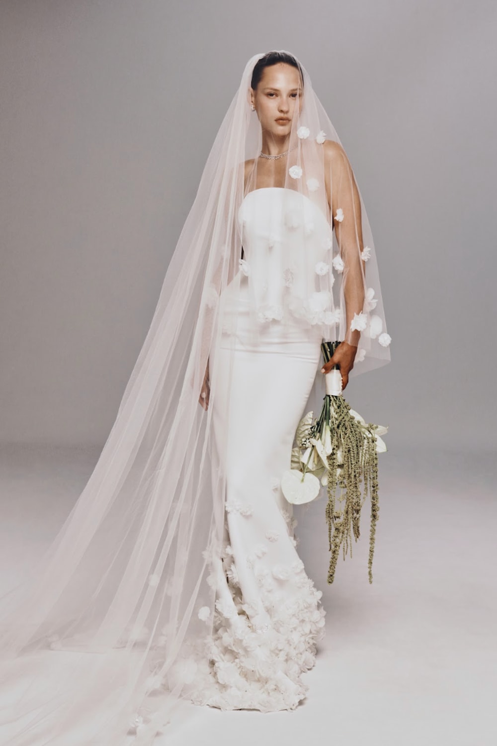 Strapless Fit-And-Flare Wedding Dress with Flower Embellishments and Detachable Train by Nicole + Felicia For Kleinfeld — image 1 of 4