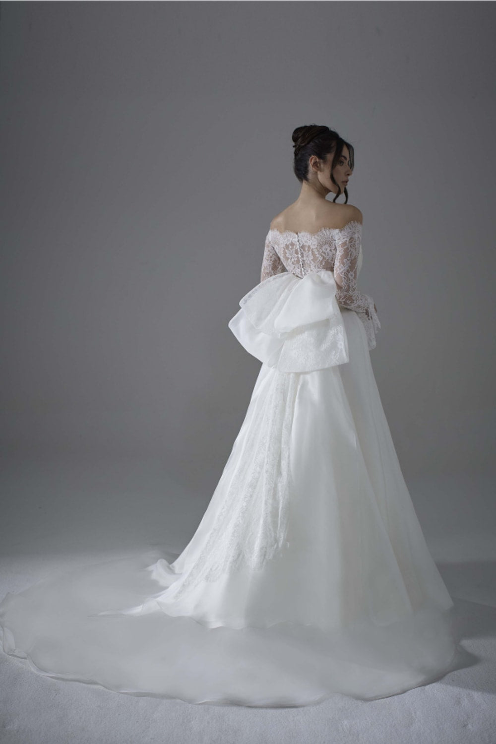 Modern A-Line Wedding Dress with Detachable Lace Topper and Bow Detail by Maison Signore — image 4 of 4