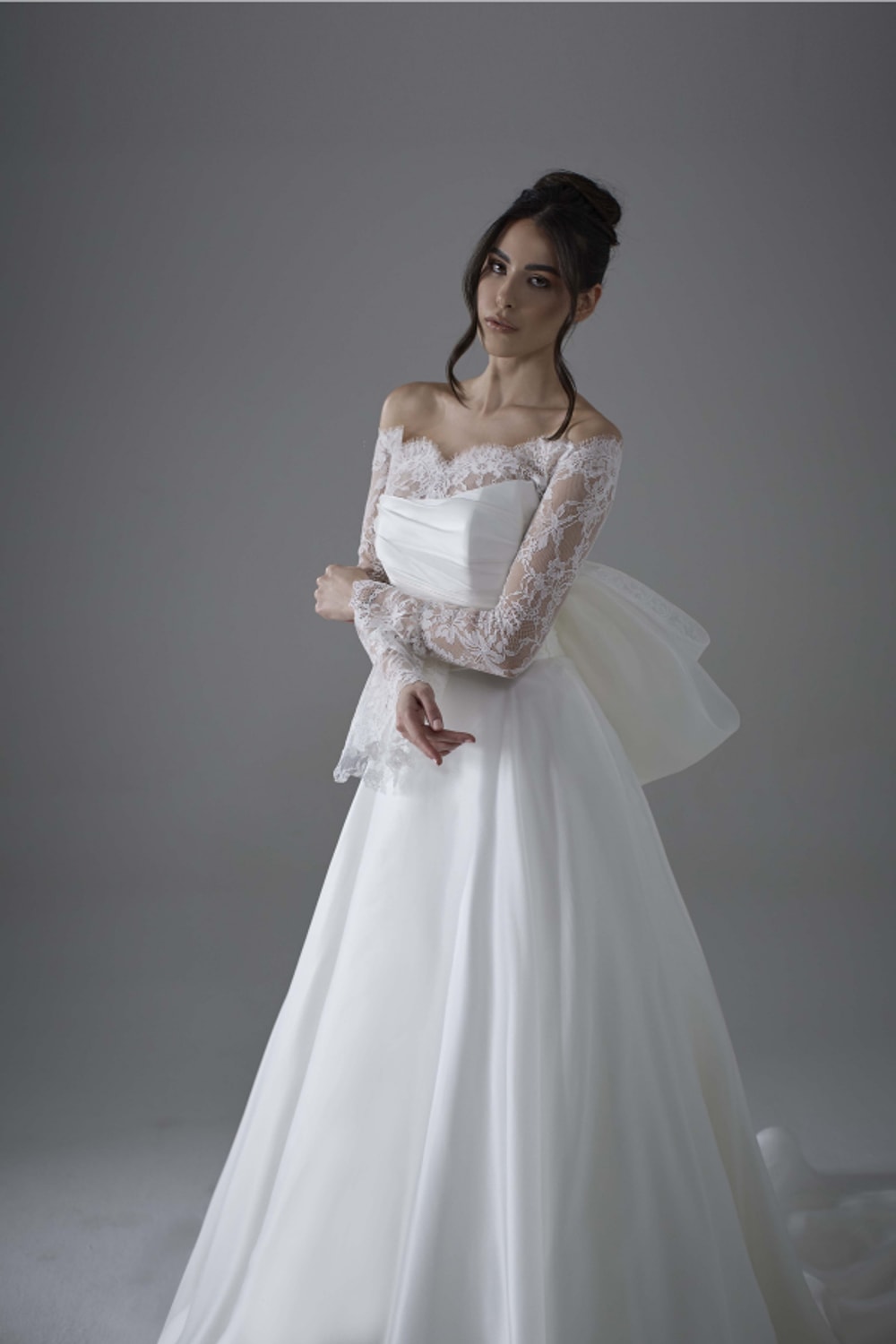 Modern A-Line Wedding Dress with Detachable Lace Topper and Bow Detail by Maison Signore — image 1 of 4