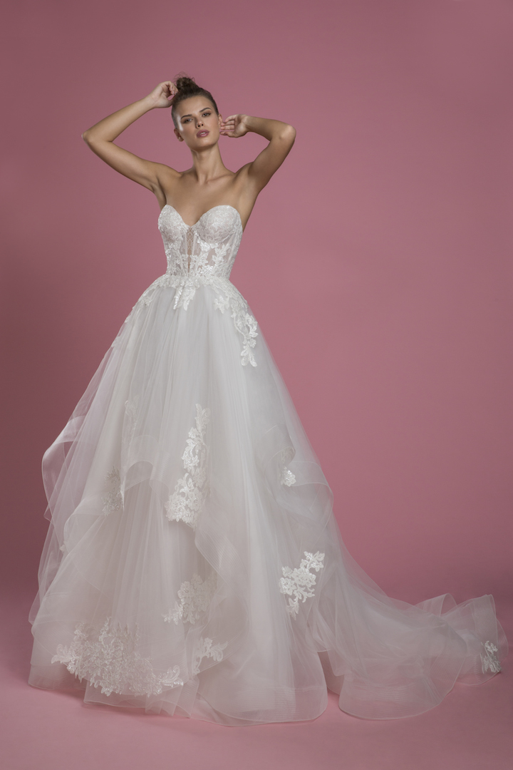 a white strapless wedding dress with a layered tulle skirt