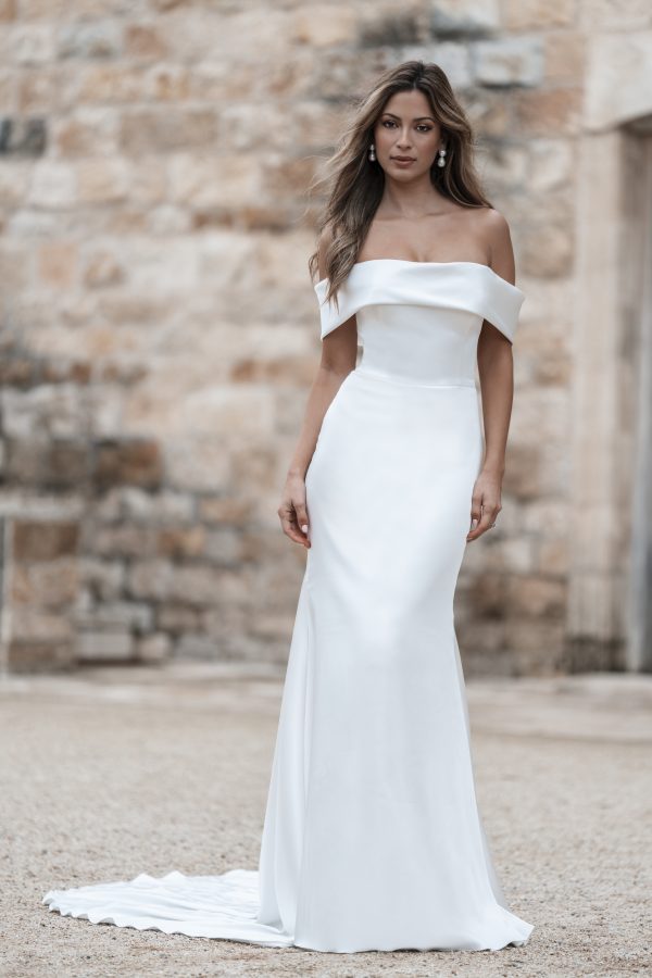 Chic And Timeless Off-the-Shoulder Sheath Wedding Dress With Buttons And Bow by Allure Bridals - Image 1