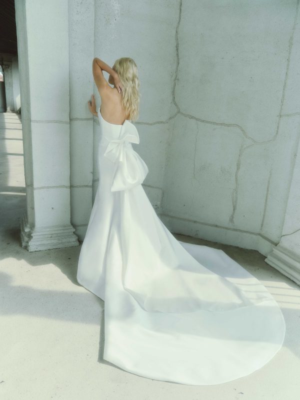 Chic and Contemporary Fit-and-Flare Wedding Dress With Abstract Bow by Rivini - Image 3